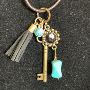 NWOT Boho style necklace. 18 inches. Brown nylon cord.